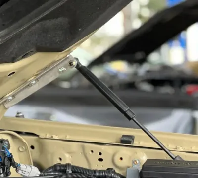 Installed Landcruiser bonnet gas struts supporting the engine hood.