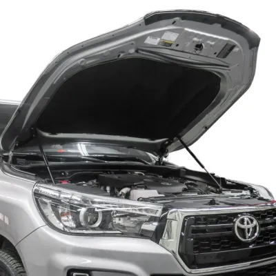 A silver Toyota engine bay showcasing the hilux bonnet struts holding the hood open securely.